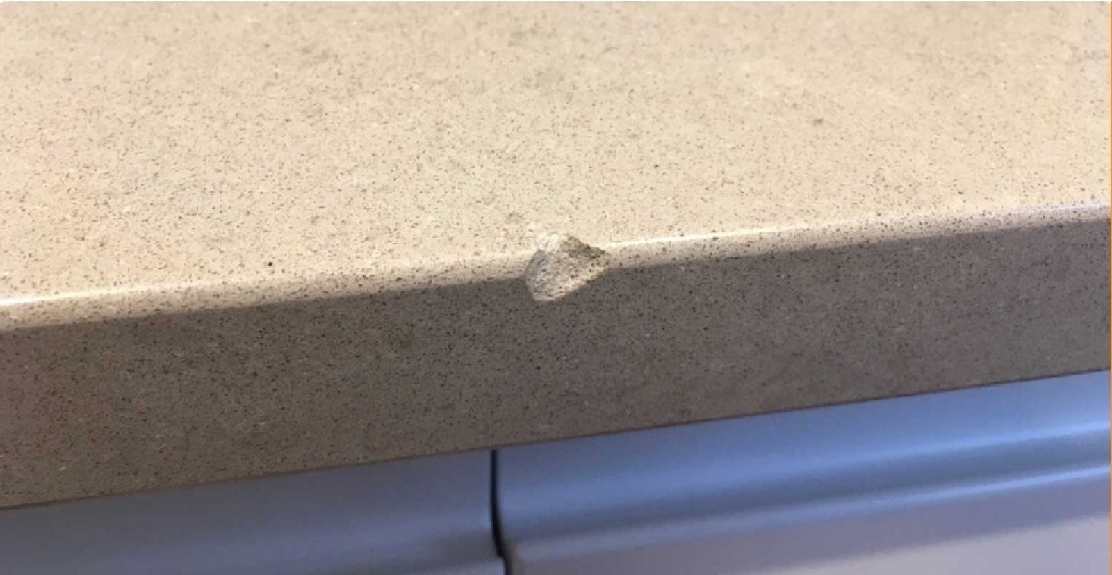 Quartz worktop chip repair — before